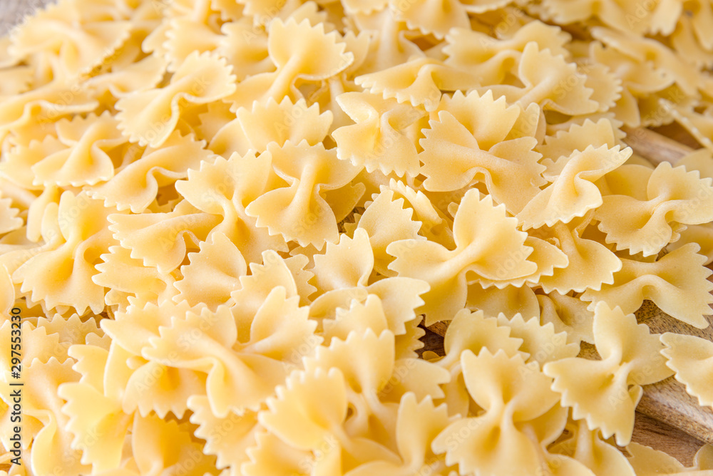 some farfalle pasta forming a background pattern some farfalle pasta forming a background pattern