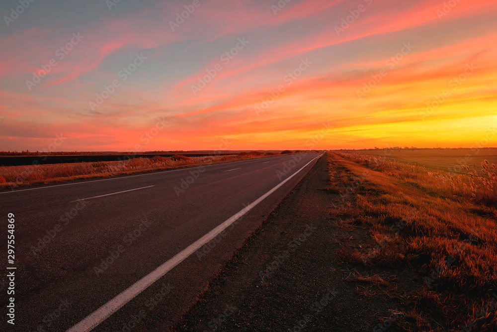 sunset road on a background of colorful sky