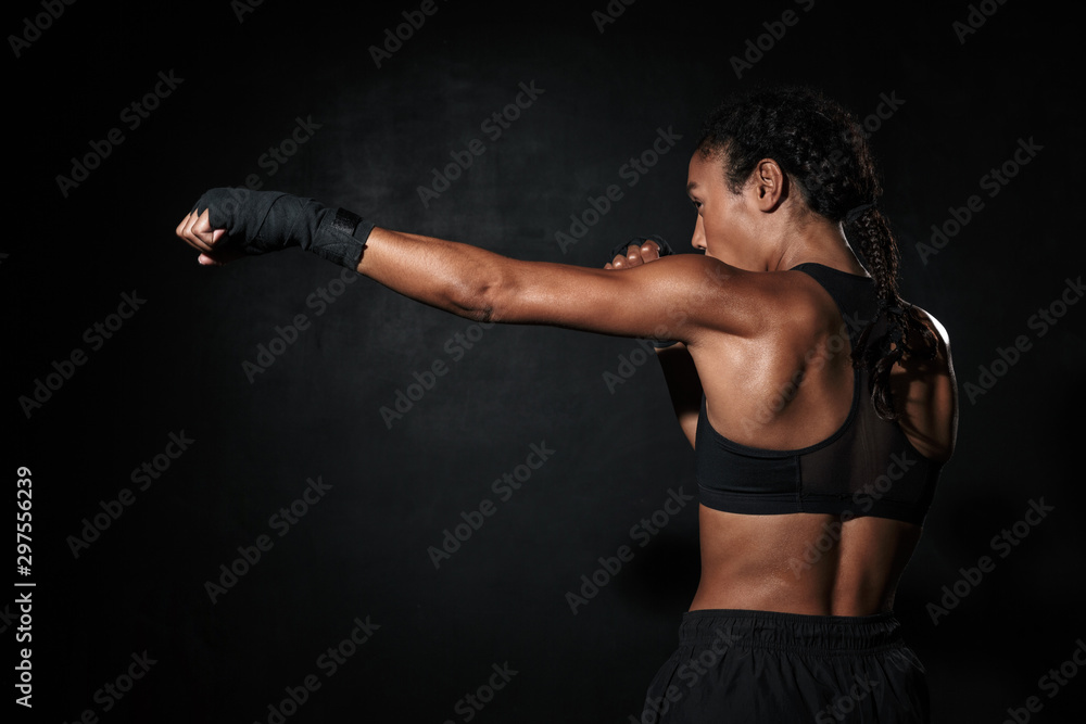 Image of muscular african american woman boxing in hand wraps Image of muscular african american woman boxing in hand wraps