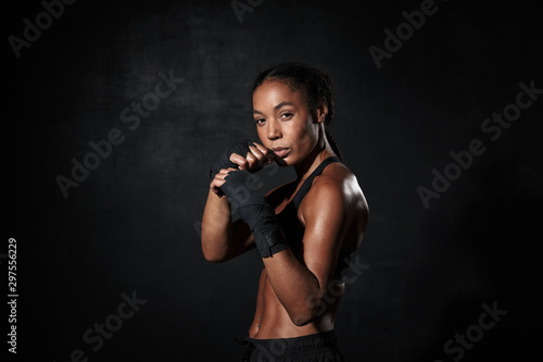 Image of strong african american woman boxing in hand wraps