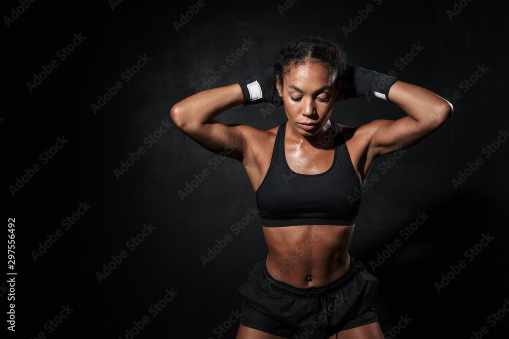 Naklejka premium Image of strong african american woman standing in boxing hand wraps