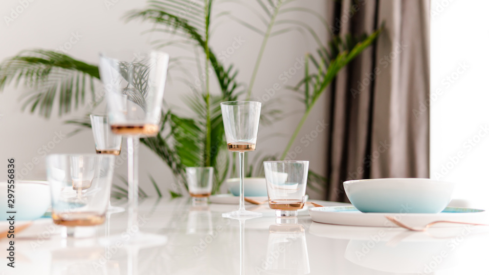 Close-up of served table in a luxury restaurant at the holiday eve. Serving dishes, glass wine glasses and gold cutlery. Close-up of served table in a luxury restaurant at the holiday eve. Serving dishes, glass wine glasses and gold cutlery.