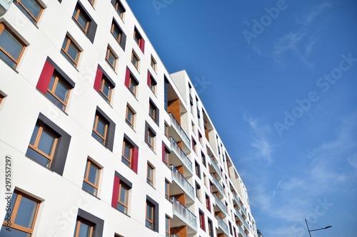 Modern apartment buildings on a sunny day with a blue sky. Facade of a modern apartment building © Grand Warszawski