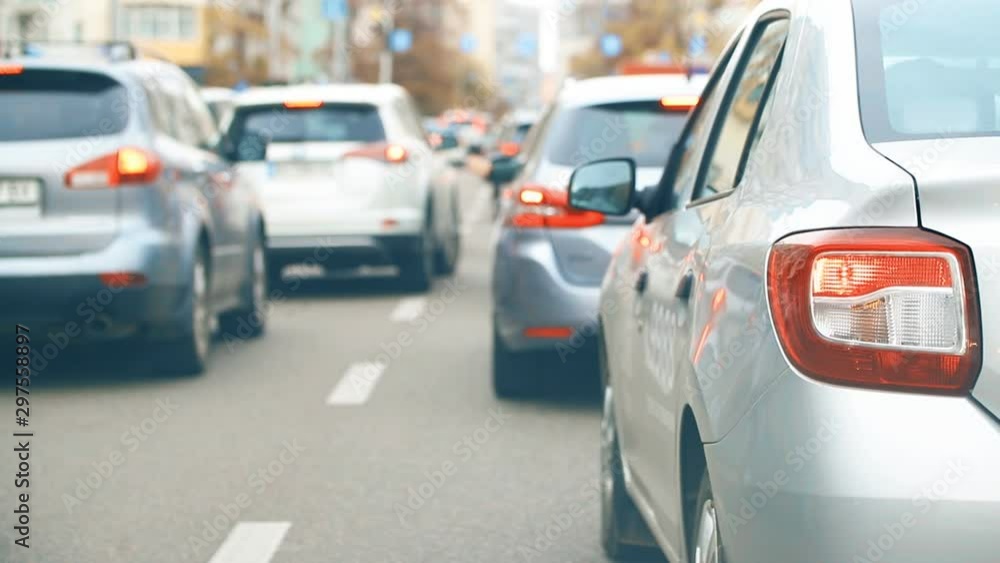 Cityscape of city road with car traffic jam with close-up vehicle rear stop lights during rush hour time. Many vehicles moving slow on street Cityscape of city road with car traffic jam with close-up vehicle rear stop lights during rush hour time. Many vehicles moving slow on street