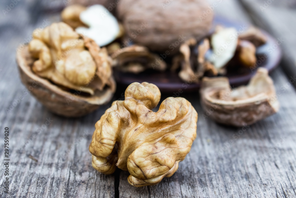 Walnuts kernels on a rustic old wooden table. Fresh walnuts. Walnuts kernels on a rustic old wooden table. Fresh walnuts.