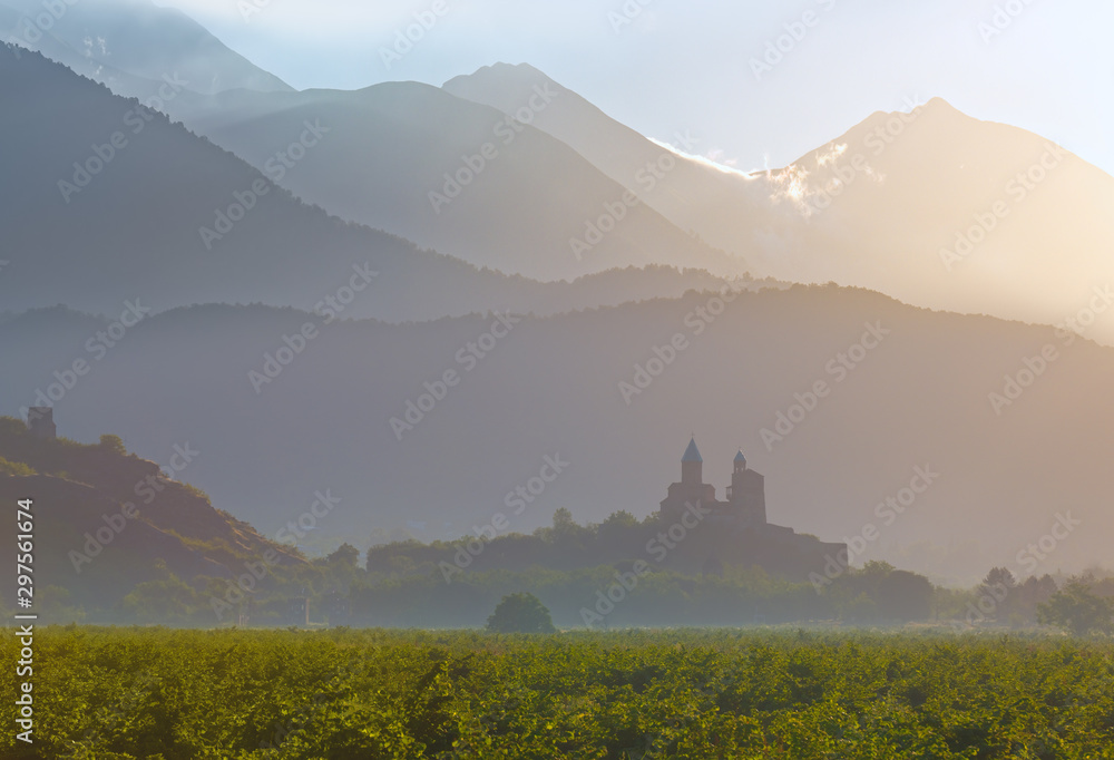 Scenic view of historic Gremi fortress at sunrise on background of mountains in Kakheti region, Georgia. - obrazy, fototapety, plakaty 