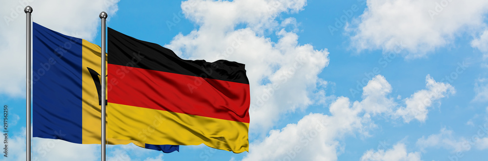 Barbados and Germany flag waving in the wind against white cloudy blue sky together. Diplomacy concept, international relations. Barbados and Germany flag waving in the wind against white cloudy blue sky together. Diplomacy concept, international relations.
