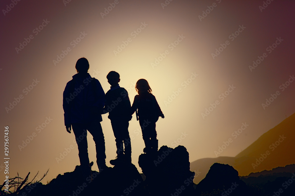 Father with kids-boy and girl- travel in sunset mountains