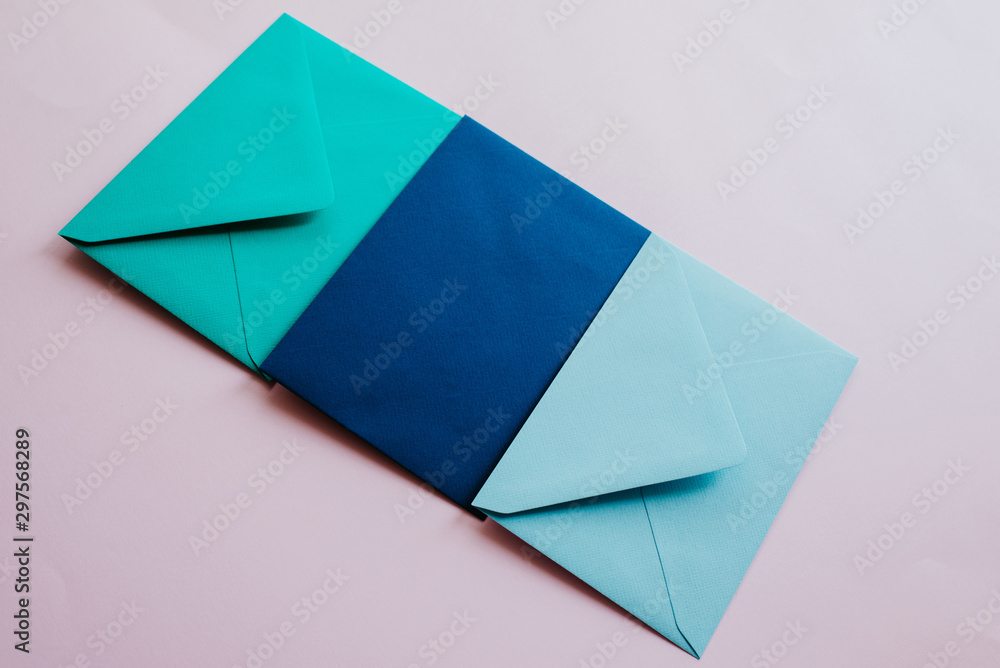 Colored paper envelopes on a light background. New mail, write message. Send and receive letter. Postal delivery service. Blank envelope, empty space. People communication, paperwork. Envelope closeup Colored paper envelopes on a light background. New mail, write message. Send and receive letter. Postal delivery service. Blank envelope, empty space. People communication, paperwork. Envelope closeup