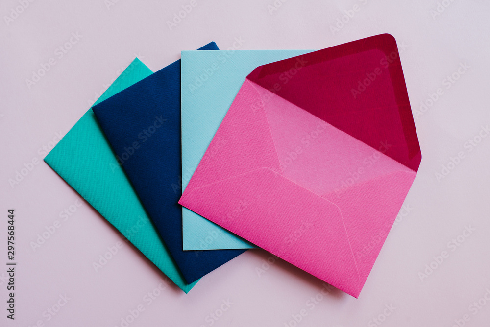 Colored paper envelopes on a light background. New mail, write message. Send and receive letter. Postal delivery service. Blank envelope, empty space. People communication, paperwork. Envelope closeup Colored paper envelopes on a light background. New mail, write message. Send and receive letter. Postal delivery service. Blank envelope, empty space. People communication, paperwork. Envelope closeup
