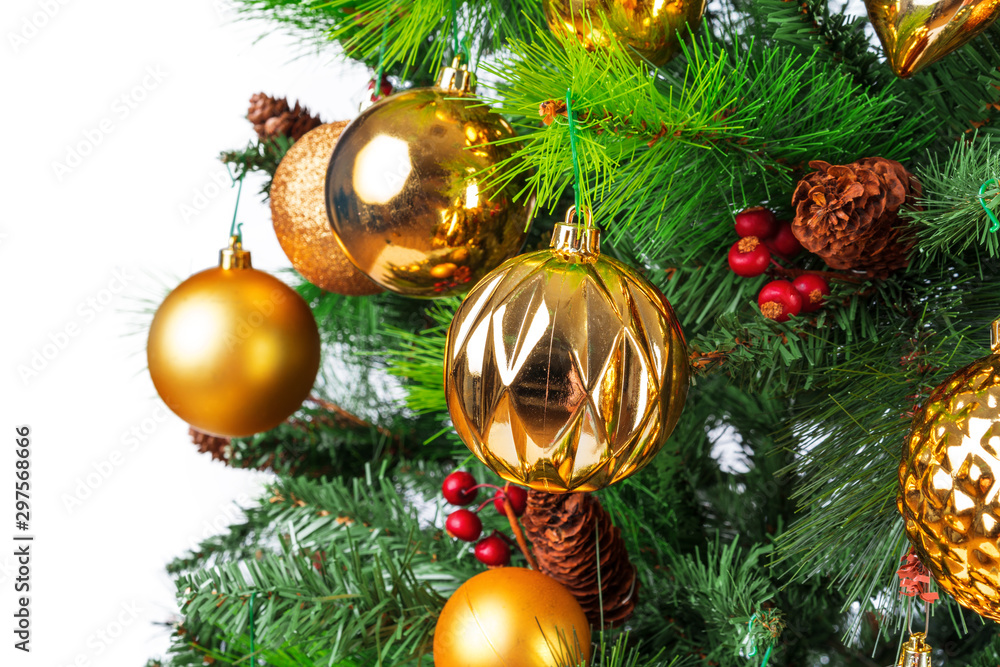 Spruce branches with golden baubles against white background Spruce branches with golden baubles against white background