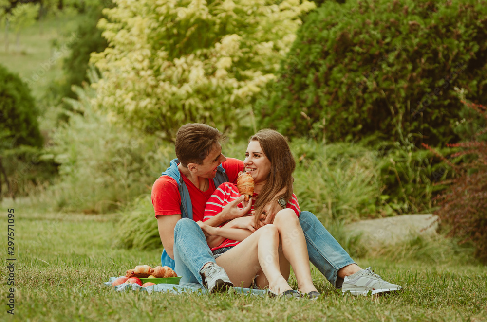 Beautiful young couple in love decided to have a romantic picnic in the park. A date, time spent together is priceless. Camping in the countryside. Beautiful young couple in love decided to have a romantic picnic in the park. A date, time spent together is priceless. Camping in the countryside.