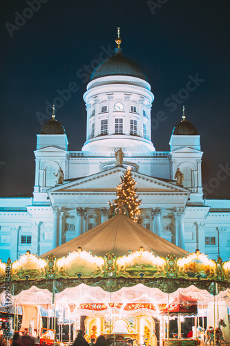 Helsinki, Finland. Xmas Market On Senate Square With Holiday Carousel And Famous Landmark Is Lutheran Cathedral In Winter Night