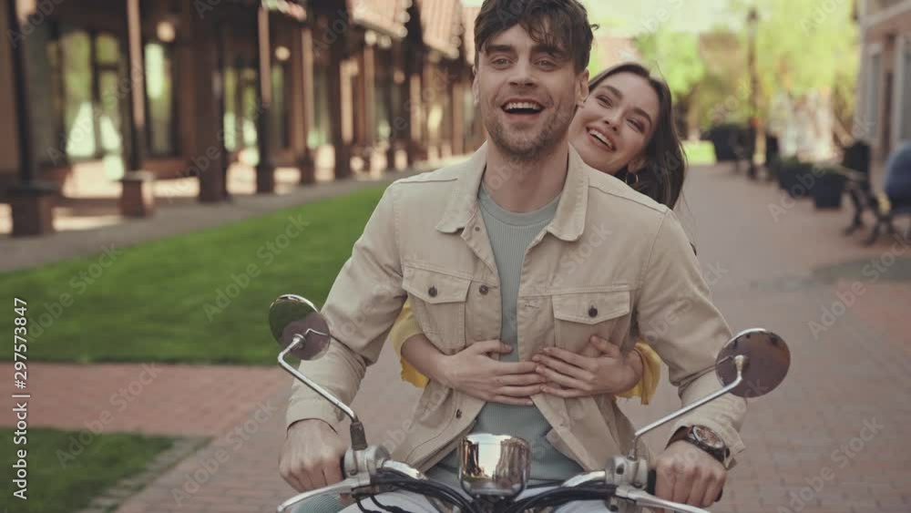woman with outstretched hands riding motorcycle with man woman with outstretched hands riding motorcycle with man