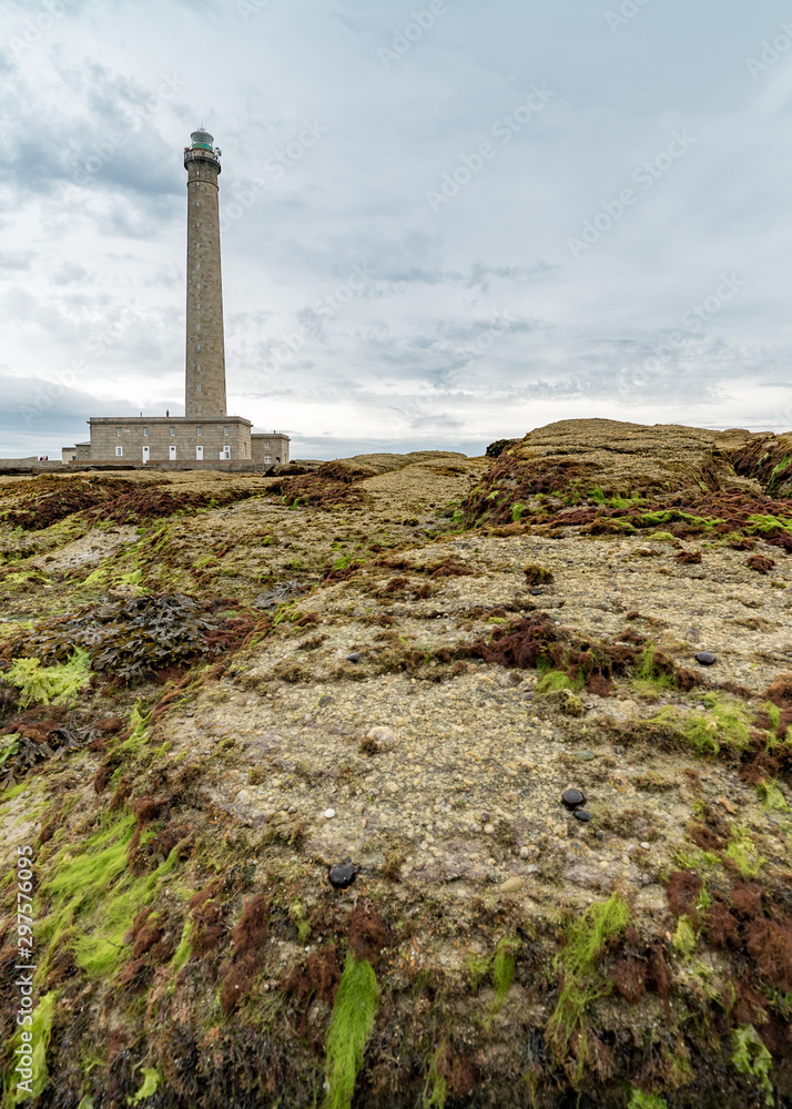 the Gatteville lighthouse with rocks and algae in the foreground
