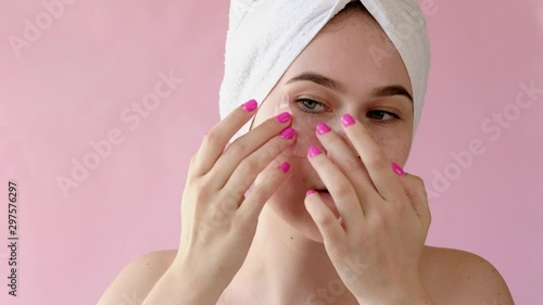 Young Woman with collagen pads under her eyes on pink background. Spa, skincare, beauty, cosmetics, wellness concept