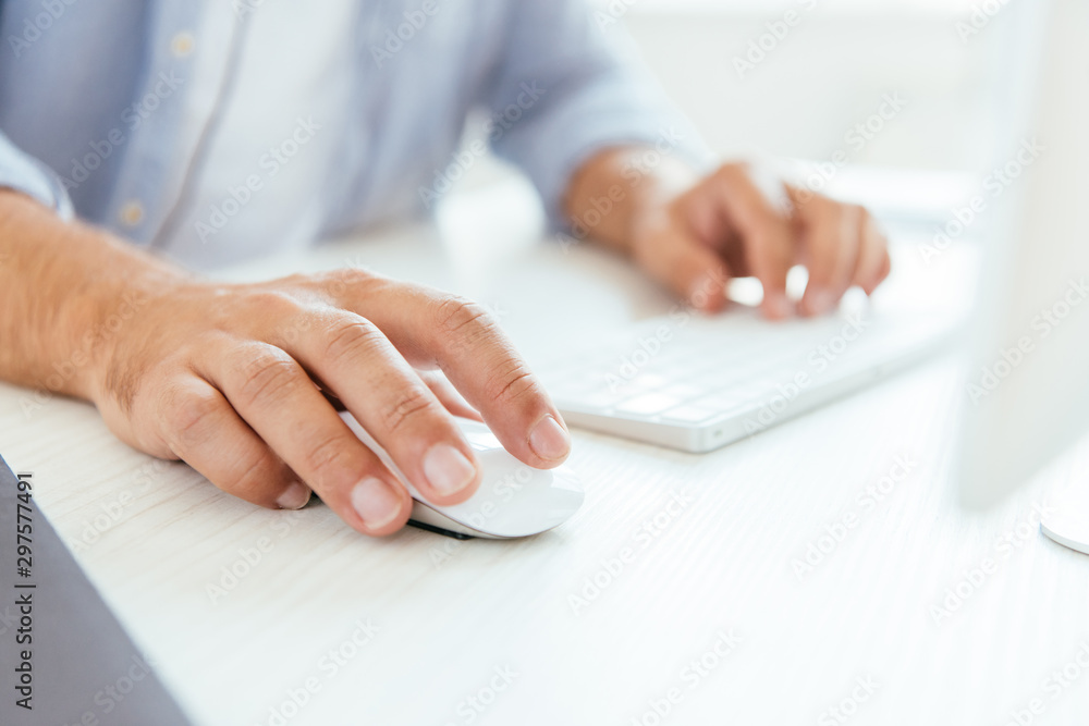 cropped view of broker using computer mouse near computer keyboard cropped view of broker using computer mouse near computer keyboard