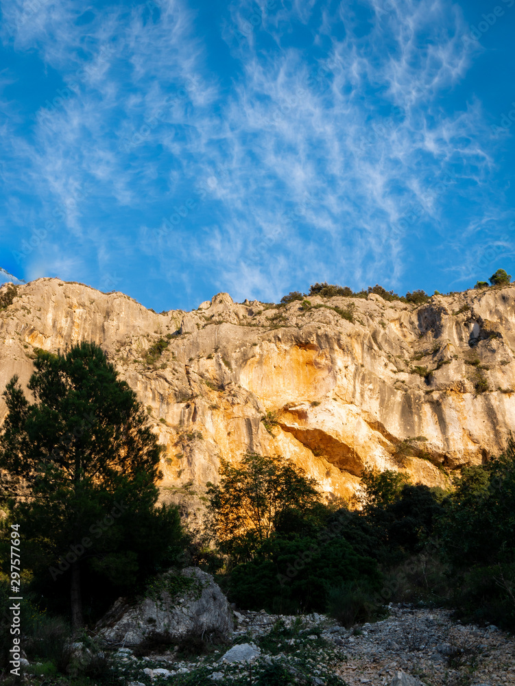 mountain with rockfall lit by the sun at sunset in the font freda