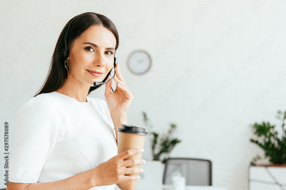 happy broker touching headset and holding paper cup happy broker touching headset and holding paper cup