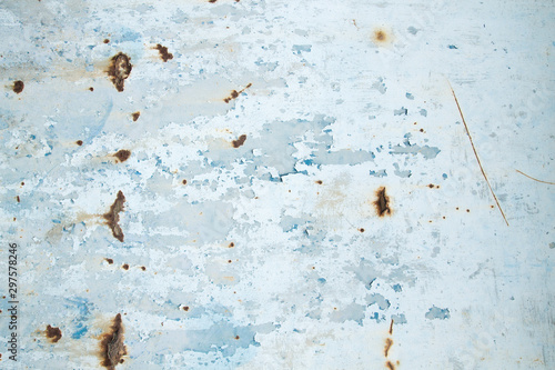 Old rusted metallic wall with blue chipping paint photo