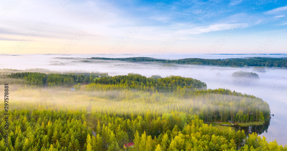 Aerial view of Pulkkilanharju Ridge, Paijanne National Park, southern part of Lake Paijanne. Landscape with drone. Fields, houses and green forests from above on a sunrise summer day in Finland.