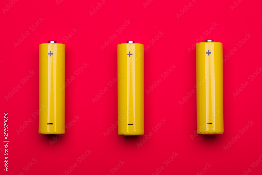 Yellow AA alkaline batteries on red background Yellow AA alkaline batteries on red background