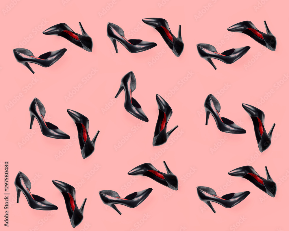 black female shoes pattern on pink coral background. Flat lay, top view trendy fashion feminine background. Beauty blog concept.