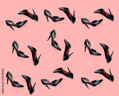 black female shoes pattern on pink coral background. Flat lay, top view trendy fashion feminine background. Beauty blog concept.