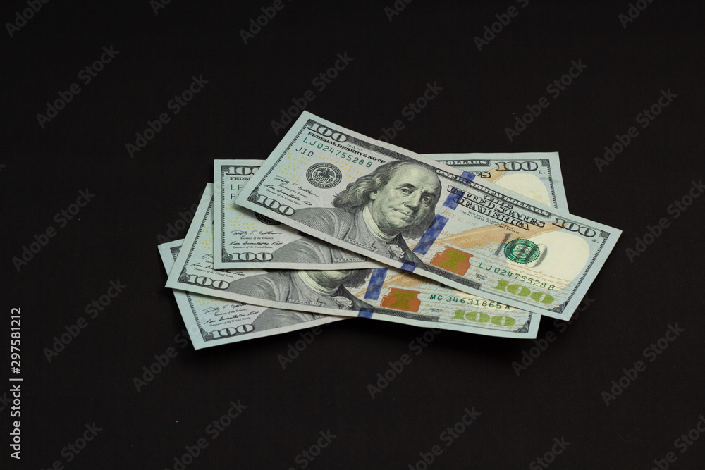 Four hundred us dollars on a black background tied with a green ribbon Four hundred us dollars on a black background tied with a green ribbon