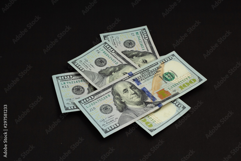 Four hundred us dollars on a black background tied with a green ribbon Four hundred us dollars on a black background tied with a green ribbon
