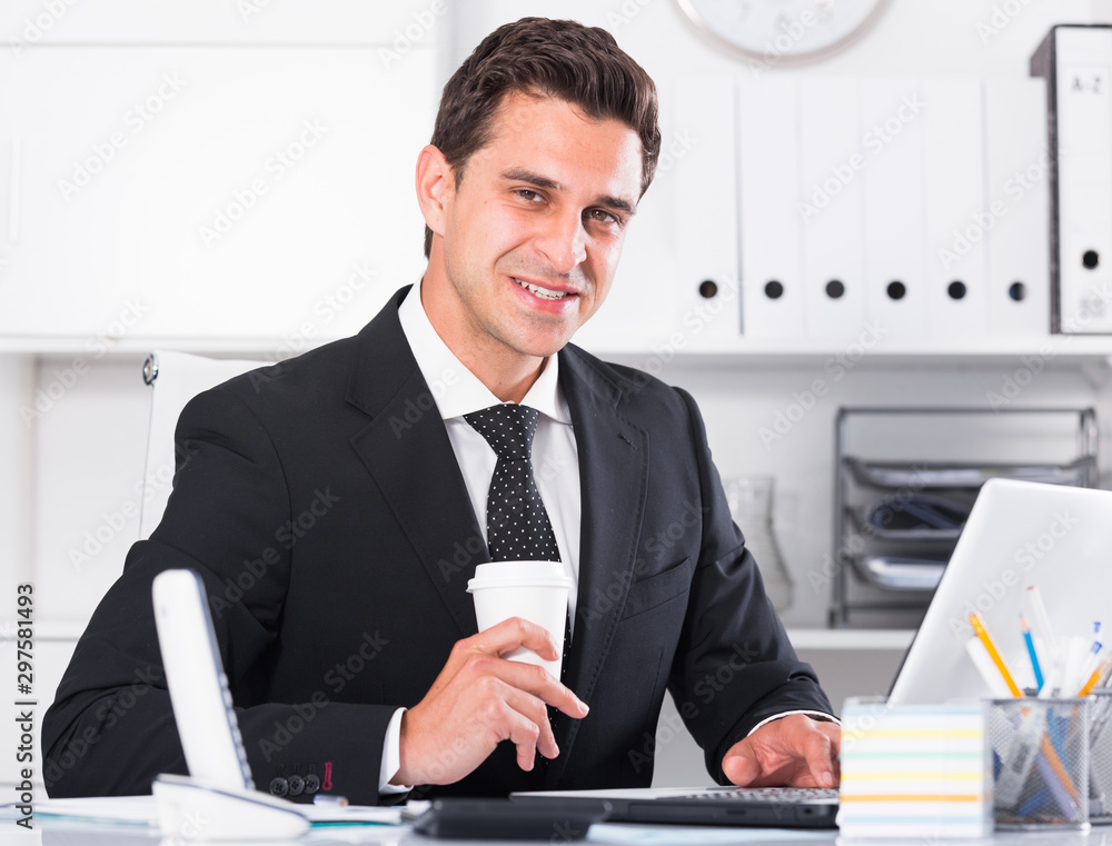 Successful businessman using laptop