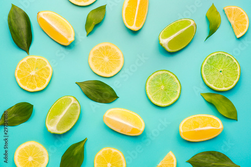 Fotografija Ripe cut lemons and limes on color background