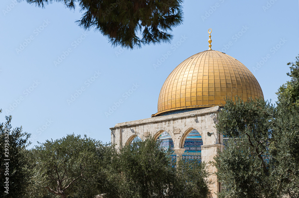 The Dome of the Rock is visible in the gap between the trees on the territory of the interior of the Temple Mount in the Old City in Jerusalem, Israel