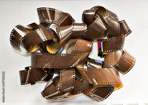 Heaps of analog photographic roll film 35 mm on isolated white background.