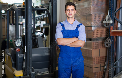 Portrait of confident male in uniform on his workplace in building store.