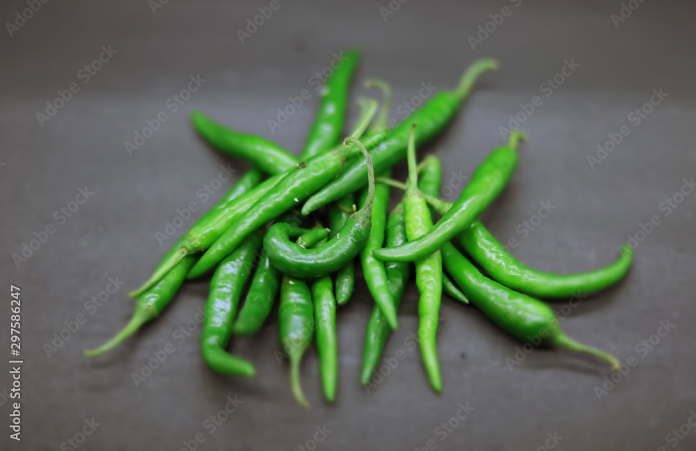 Fresh green chilli on black background. Top view Fresh green chilli on black background. Top view