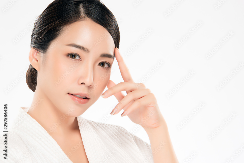 Beautiful Asian young woman touching soft cheek and smile with clean and fresh skin. Happiness and cheerful with, isolated on white background, Beauty and Cosmetics Concept,