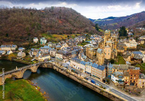 Fototapeta Naklejka Na Ścianę i Meble -  Aerial view of Estaing with castle and arched bridge
