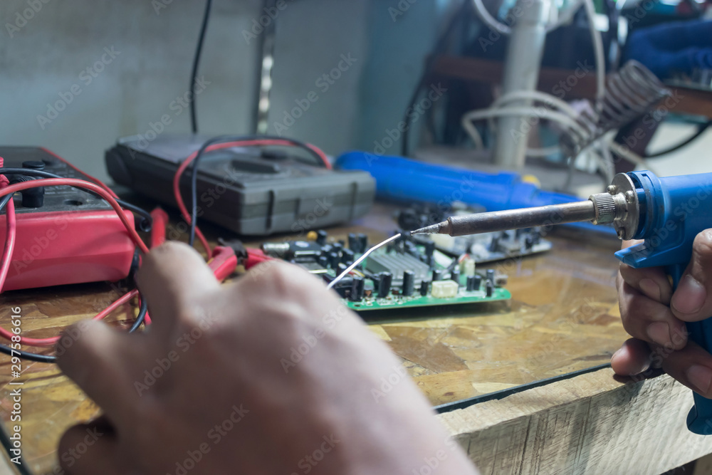 Technicians use a soldering iron and lead to repair electronic circuits.