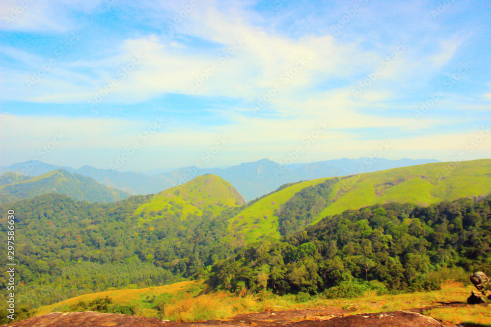 Blue sky and green valley view from rosemala, aryankavu, kerala