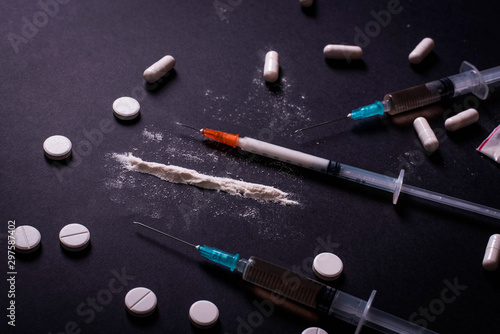 Hard drugs on dark table. concept of crime and addiction. Drug heroin, syringes