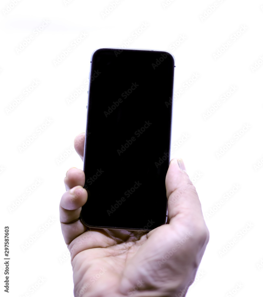 Female hand holding black cellphone at isolated background. Female hand holding black cellphone at isolated background.