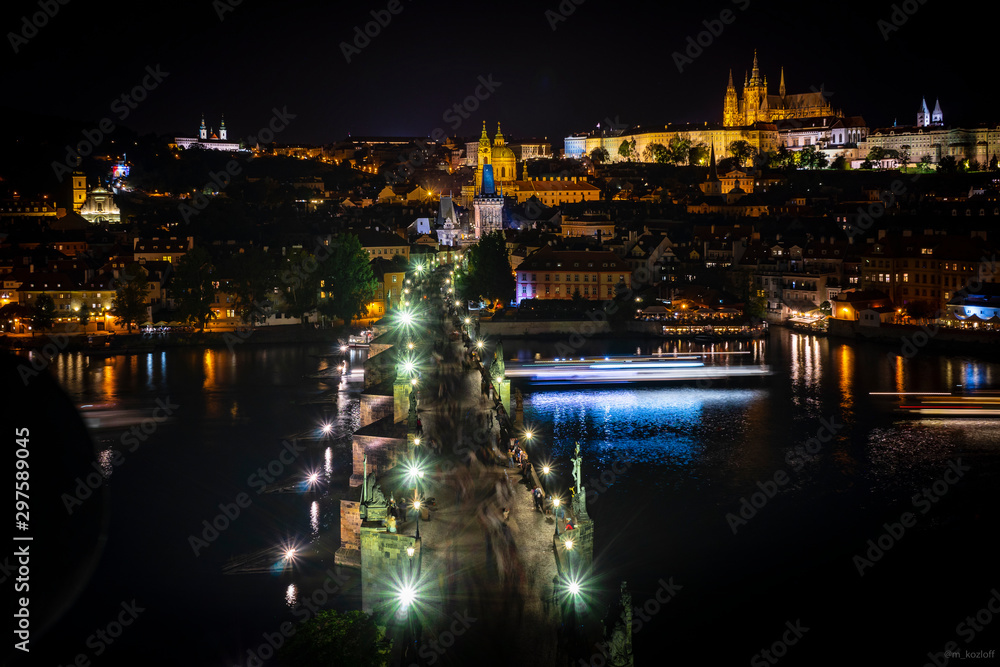 Beautiful low angle view of Charles Bridge from Old Town Bridge Tower at night. Long exposure. Holidays in Prague