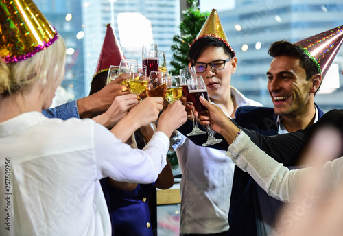 Business men and women with glasses of champagne and wine celebrating Christmas and New Year for success in Business at the Office/Anniversary photo