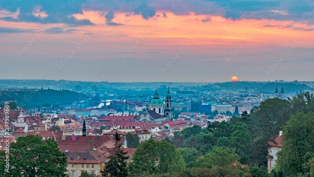 A beautiful spring view of Prague at sunrise from Petrin hill. Pink rising sun in the background. Holidays in Prague