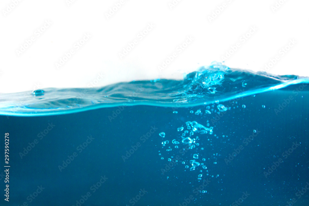 Obraz close-up shot of blue water surface and shining blue bubbles underwater with white background