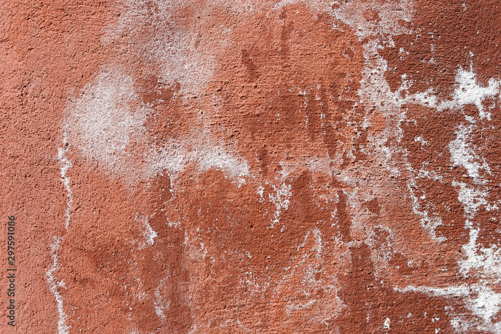 Fototapeta premium Texture of old cement plaster painted red. Weathered painted wall background texture