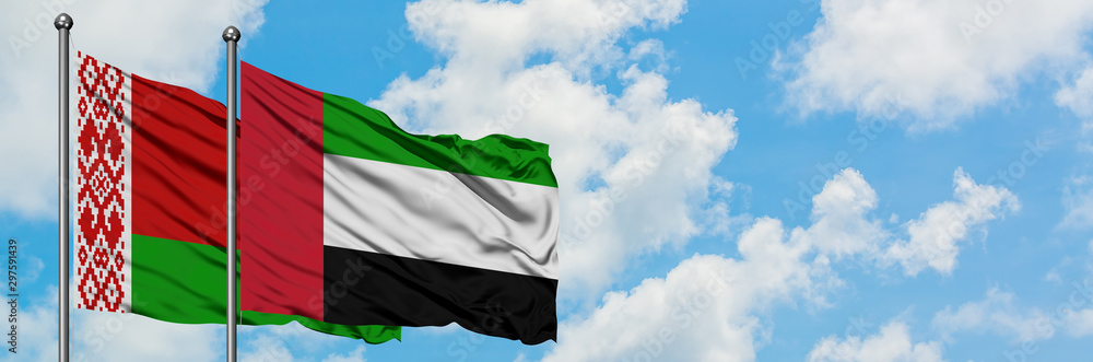 Belarus and United Arab Emirates flag waving in the wind against white cloudy blue sky together. Diplomacy concept, international relations. Belarus and United Arab Emirates flag waving in the wind against white cloudy blue sky together. Diplomacy concept, international relations.