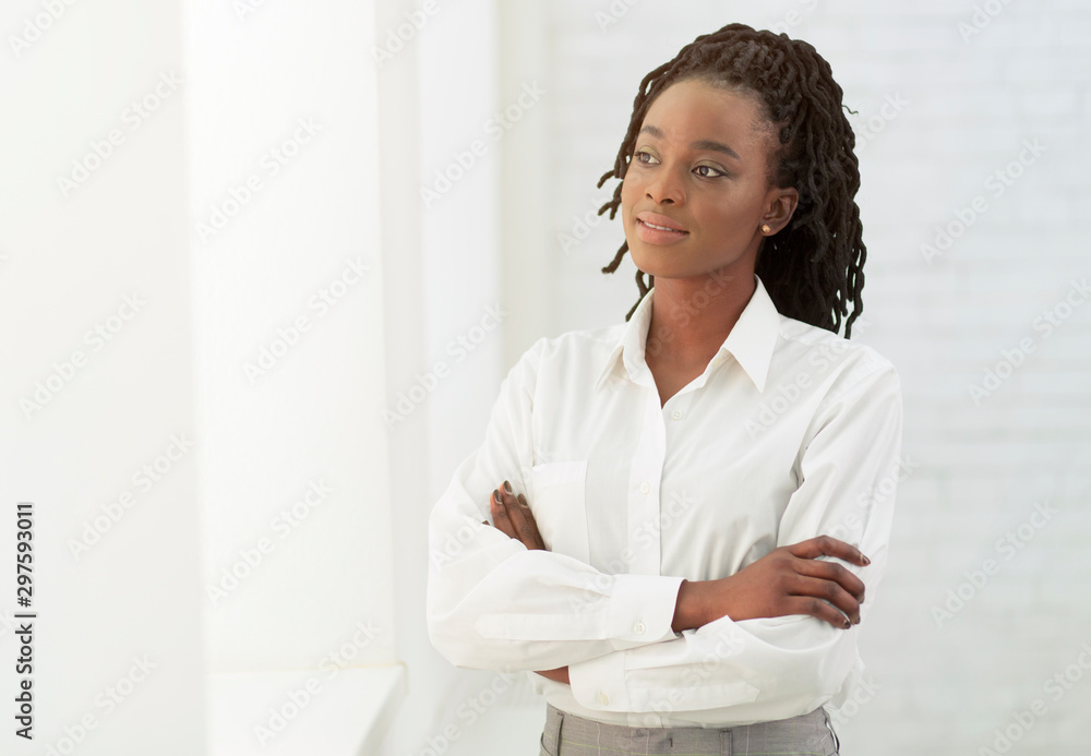 Afro Office Girl Crossing Hands Standing Next To White Wall Afro Office Girl Crossing Hands Standing Next To White Wall
