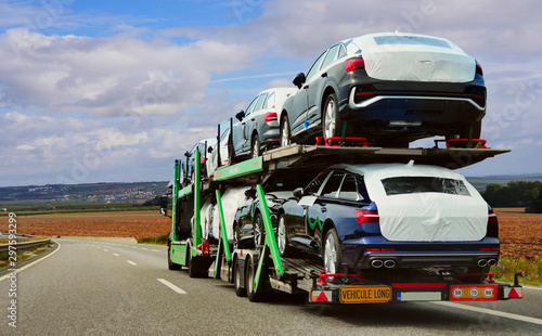 Photo The trailer is engaged in the delivery of new cars to their place of sales